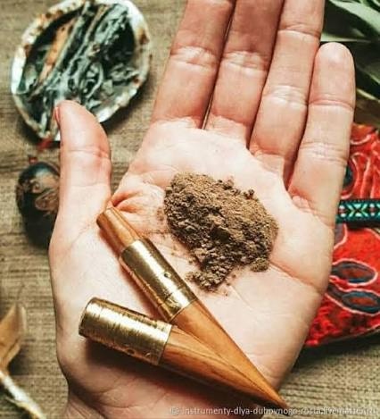 Rapé sacred tobacco powder and tepi pipe held in an open hand